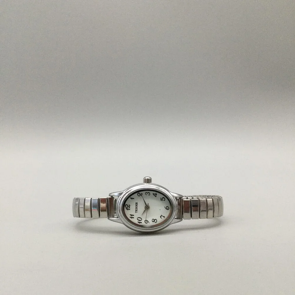TKIIOER Womens Watch 19mm Silver Tone White Oval Dial Stretch Band New Battery
